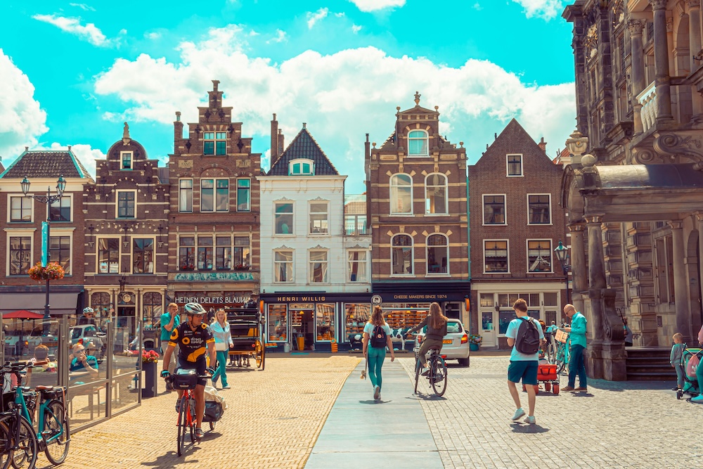 Typical city square in Delft with traditional houses and people living their lives