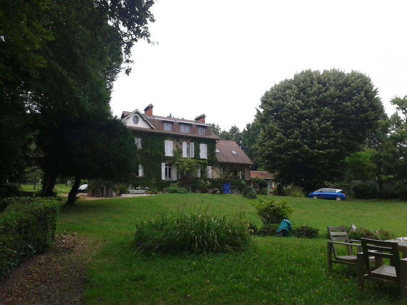 A large house in the French countryside, surrounded by trees