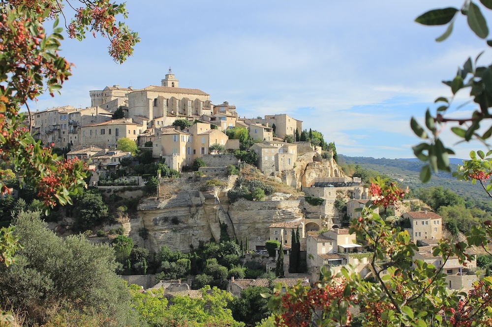 The picturesque village of Gordes in the Provence region, with its old buildings positions on a wooded hill