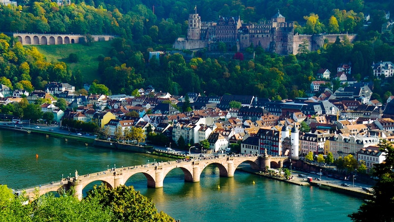 Aerial view of Heidelberg, the Neckar river, a large roman bridge, and the Heidelberg castle