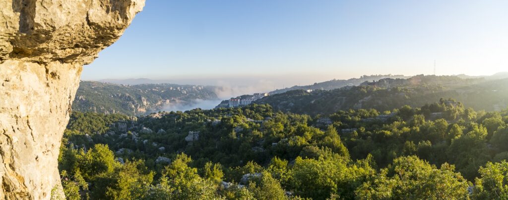 Sunrise over a valley in the Lebanese mountains, with mist at the bottom